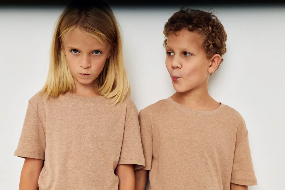 Siblings fighting and having defiant facial expressions.